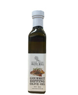 Rectangular glass bottle with a white label portraying a picture of a variety of spices and herbs and the words "Gourmet Dipping Olive Oil".