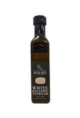 Rectangular glass bottle with black label portraying a picture of a barrel and the words "White Balsamic Vinegar" in white.