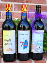 three red wine bottles in front of brick wall