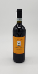 dark glass wine bottle with black foil around bottle neck and mustard yellow front label