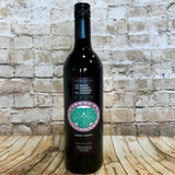 dark glass wine bottle with black and green front label