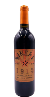 Wine bottle with Winery 1912 front label in tones of copper and black. 