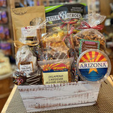 The contents of the Nothin' But Snacks inside of a faux white wood basket. The front of the baskets clearly displays the chocolate truffles and the nut tub that reads "Nuts about Arizona".