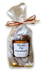 Plastic food bag containing brown colored caramels tied with brown ribbon.