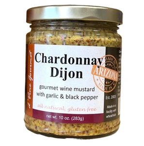 round clear glass jar with gold lid containing whole grain mustard