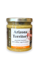 Round glass jar with gold lid containing yellow colored mustard. Round glass jar with gold lid containing yellow colored mustard.