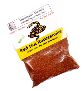 Plastic food bag containing red colored seasoning topped with printed cardboard imprinted with rattlesnake graphic.