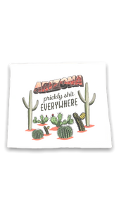 White dish towel with Arizona along the top, many cacti, and the phrase Prickly Shit Everywhere