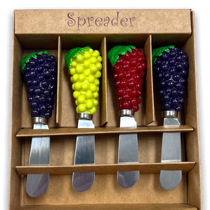 Four grape shaped handle of cheese spreaders in green, red and two in purple in a tan display gift box.