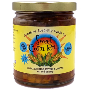 Round clear glass jar with gold lid containing corn relish