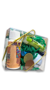 square clear plastic gift box with green crinkle fill tied with elastic gold bow