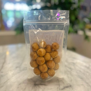 Back of clear packaging showing contents of brownish orange dog treat balls