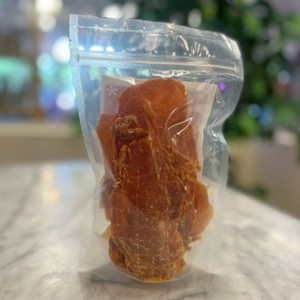 Back side of clear packaging showing long light brown dog treats