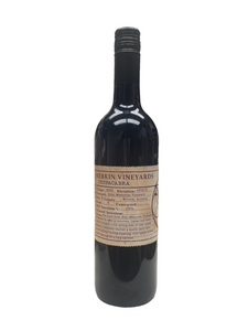 Tall dark glass wine bottle with light brown front label