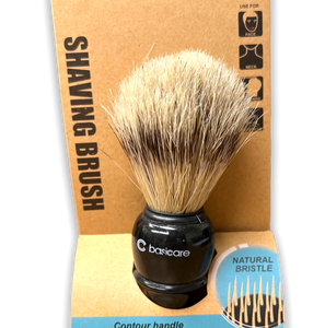 Shaving brush with tan bristles, black handle on a tan cardboard backing