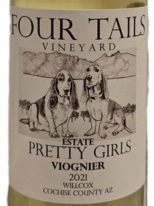 glass wine bottle with white label with drawing of  dogs