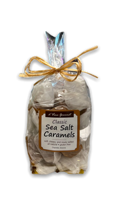 Plastic bag filled with brown caramels and tied with brown ribbon.