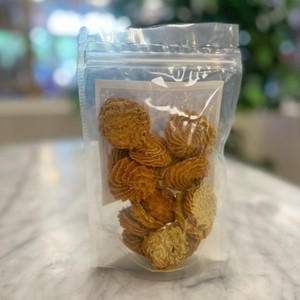 Back side of clear package showing round dog treats