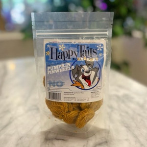 Clear plastic resealable food pouch showing contents of light brown dog treats with blue and white front label