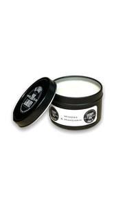 round black metal tin with lid containing white candle wax round black metal tin with lid containing white candle wax