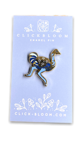 Enamel pin in the shape of a ostrich in shades of blue and gold.