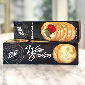 Two stacked Black long, rectangular box with image of crackers and lettering in black