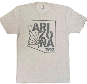 Light gray tee with design on the chest; a darker gray design with outline of Arizona, inside is "ARIZONA" in stacked letters and "1912" in smaller print Light gray tee with design on the chest; a darker gray design with outline of Arizona, inside is "ARIZONA" in stacked letters and "1912" in smaller print