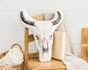 White cow skull shaped pillow with photograph image of a cow skull