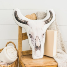 White cow skull shaped pillow with photograph image of a cow skull