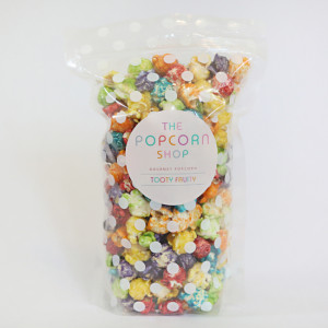 Clear plastic food bag with a zip top closure containing multi-colored popcorn