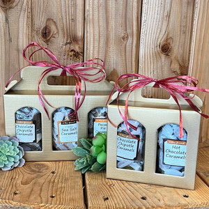 Two gift boxes displayed on a wooden table