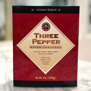 a burgundy floral box with a pale yellow diamond on the front. within the diamond it says "three pepper water crackers. a savory cracker that's perfect for any occasion." 
