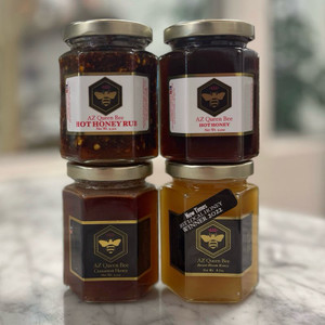 Group of four AZ Queen Bee Honey products; desert bloom, cinnamon infused, hot honey, and hot honey rub Group of four AZ Queen Bee Honey products; desert bloom, cinnamon infused, hot honey, and hot honey rub