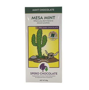 White and green rectangular box with a picture of a cactus, rock, and a bull skull.