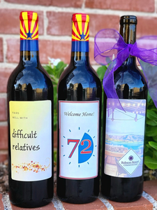 three red wine bottles in front of brick wall