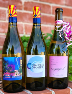 three white wine bottles on brick wall