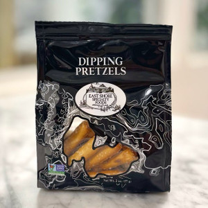 Black bag with "Dipping Pretzels" written on the top in white lettering, above the East Shore Specialty Foods logo. A clear window shows some of the pretzels inside