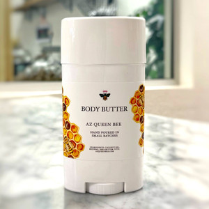 white dial-up style container. Label has drawing of bees on honeycomb with the label reading "Body Butter AZ Queen Bee"