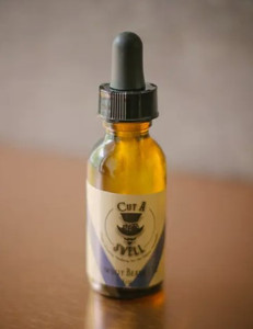 A small amber bottle with black dripper-style top.