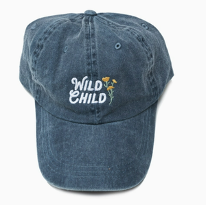 Blue baseball style hat with the words "Wild Child" in white with small yellow flowers