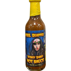 Thin glass bottle showing dark red liquid contents with blue and yellow label