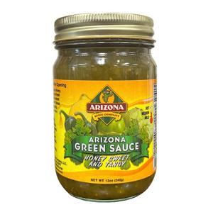 Clear glass jar with gold lid showing contents of green salsa with yellow front label and images of tomatillos. 
