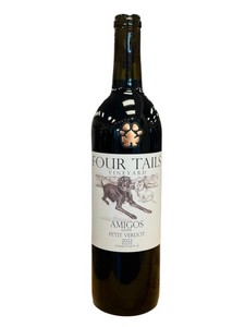 Dark glass wine bottle with light tan front label with image of two dogs laying down.