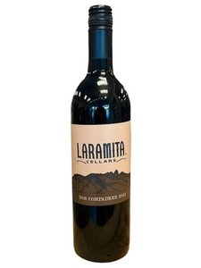 Dark glass wine bottle with tan front label with image of hills
