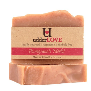 Light pink bar of soap with tan paper wrapping for a label with dark pink writing