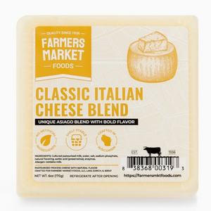 Square block of cheese in clear packaging with off white square front label and yellow lettering