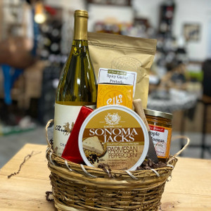 Small brown wicker basket filled with brown crinkle paper and snacks. See product description for full details of what items are included.
