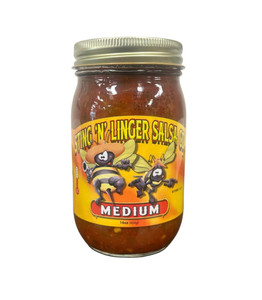 A tall cylindrical glass jar with gold lid containing red salsa; the label says “Sting N Linger Salsa” across the top in yellow font, the companies logo of two cowboy-like bee’s in the middle