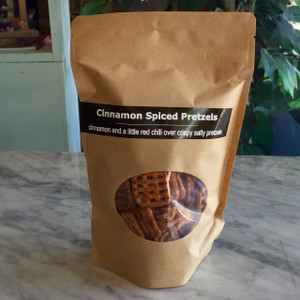 brown paper bag with clear front window displaying pretzels