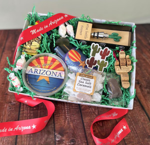 A white box with green filling and products laying flat inside the box with a red ribbon draped on top and around the box. Please see description for product details. A white box with green filling and products laying flat inside the box with a red ribbon draped on top and around the box. Please see description for product details.